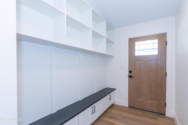 mudroom featuring light wood-style floors and baseboards