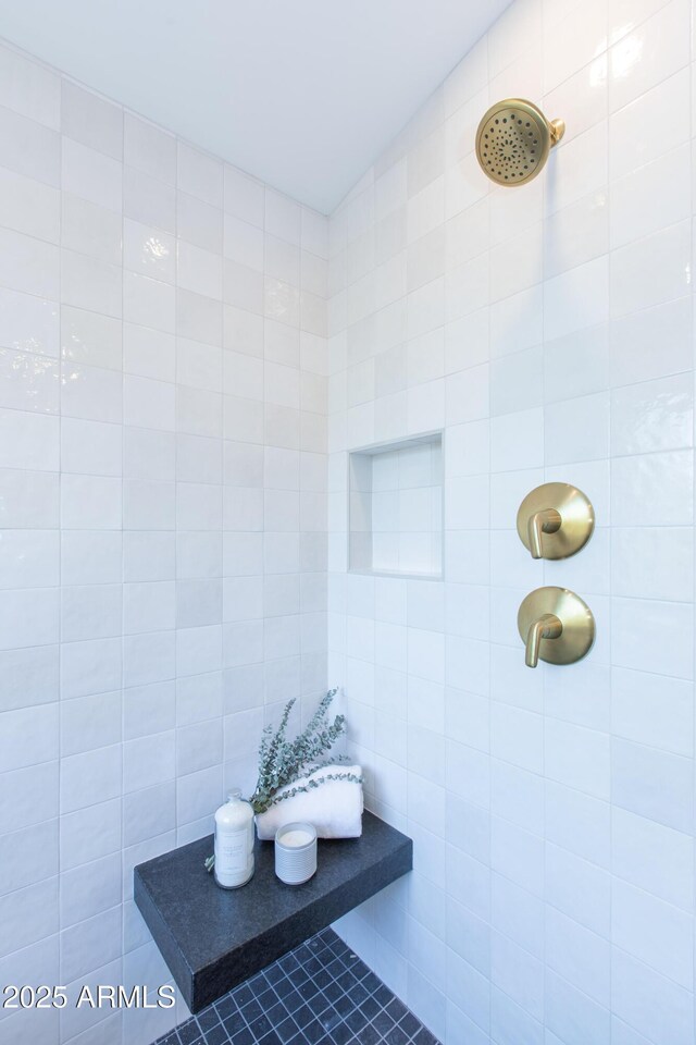 full bathroom with tiled shower
