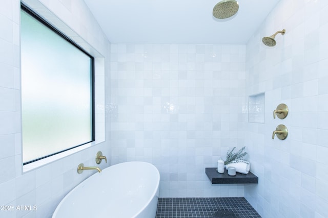 bathroom with tile walls, tiled shower, a soaking tub, and tile patterned flooring