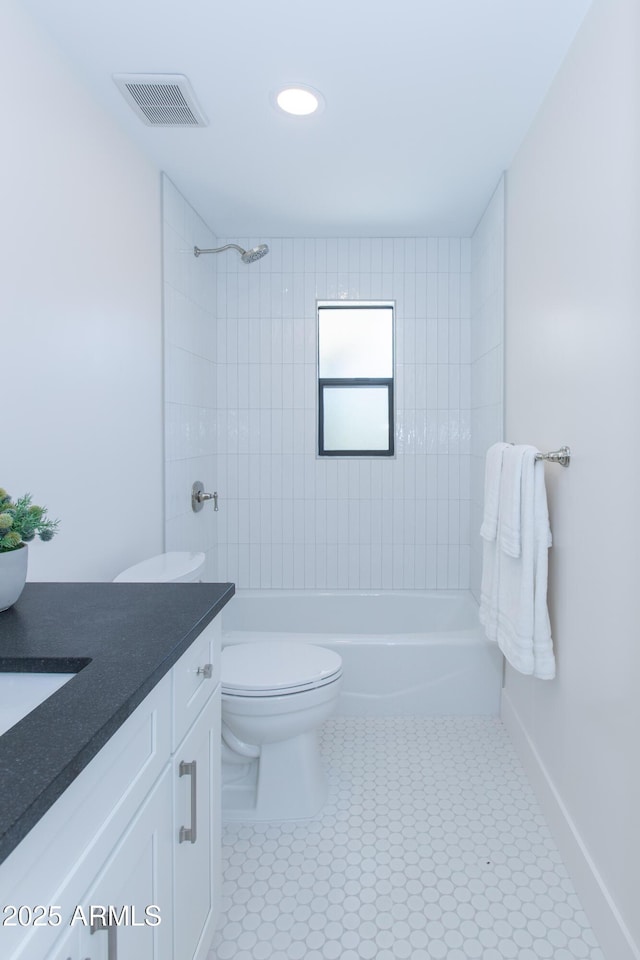 bathroom with toilet, shower / tub combination, vanity, tile patterned flooring, and baseboards