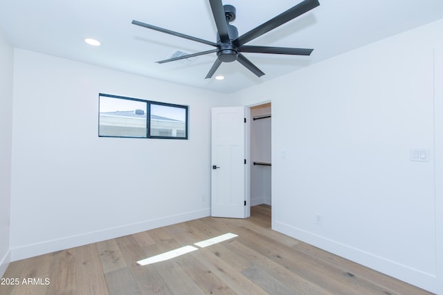 unfurnished bedroom featuring baseboards, recessed lighting, and wood finished floors
