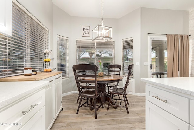 dining space featuring a notable chandelier and light wood-type flooring