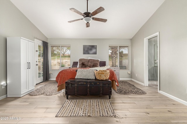 bedroom featuring connected bathroom, multiple windows, and light hardwood / wood-style flooring