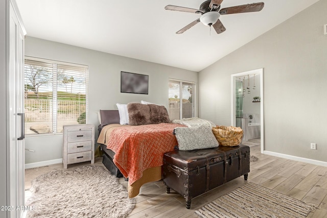 bedroom featuring lofted ceiling, ensuite bath, ceiling fan, and light wood-type flooring