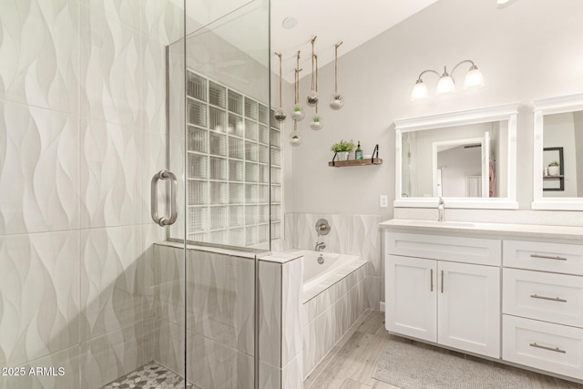 bathroom with vanity, vaulted ceiling, and independent shower and bath