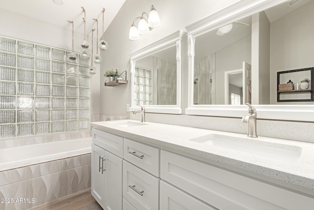 bathroom with vanity, plus walk in shower, and a wealth of natural light