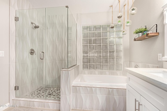 bathroom with vanity and separate shower and tub