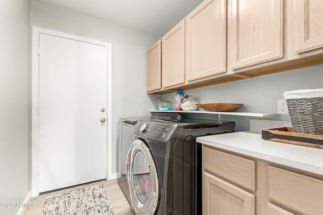 laundry room with cabinets, separate washer and dryer, and light hardwood / wood-style flooring