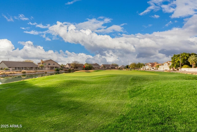 view of property's community featuring a water view and a yard