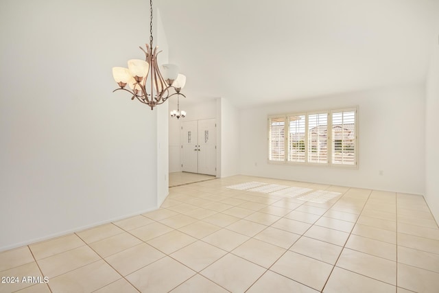 unfurnished room featuring light tile patterned floors and a chandelier