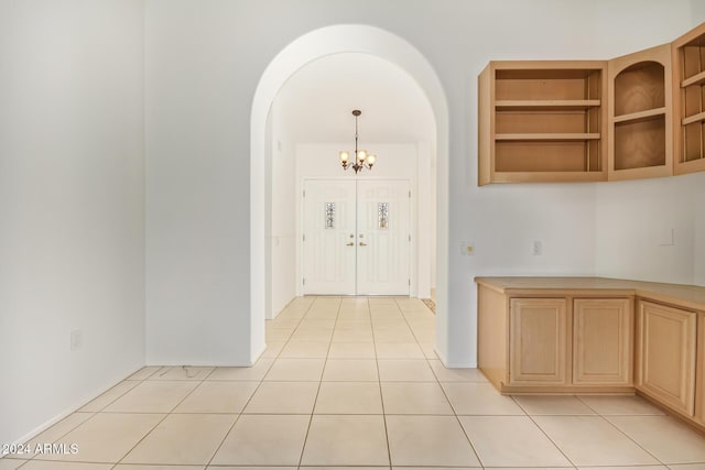 interior space featuring light tile patterned floors and an inviting chandelier