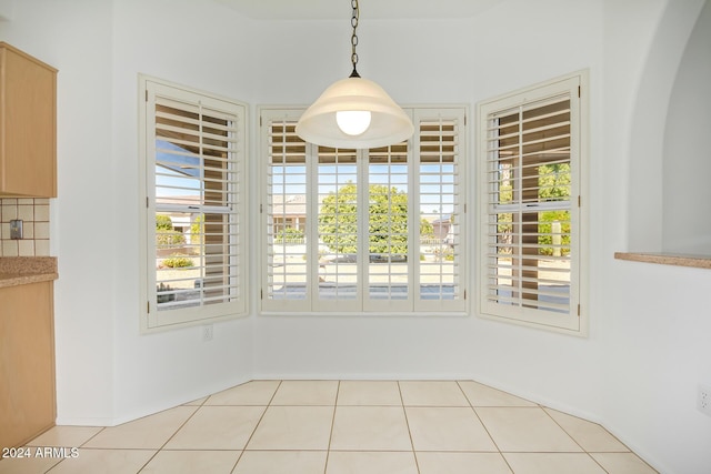 unfurnished dining area with plenty of natural light and light tile patterned floors