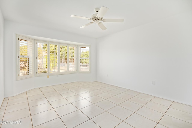 tiled empty room featuring ceiling fan