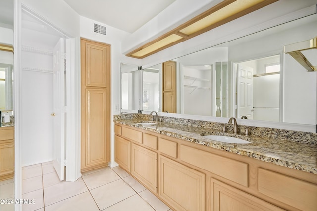 bathroom featuring tile patterned flooring and vanity