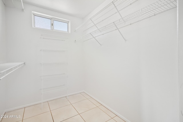 spacious closet featuring light tile patterned floors