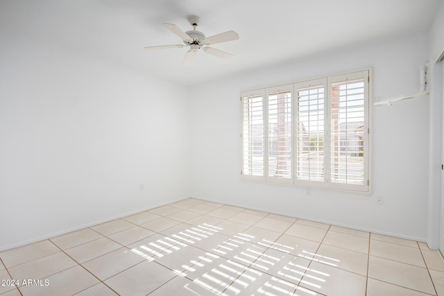 unfurnished room with ceiling fan and light tile patterned floors