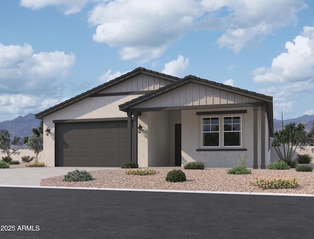 view of front of property with a garage and a mountain view