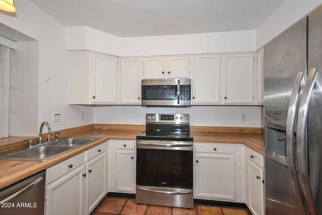 kitchen featuring appliances with stainless steel finishes, sink, and white cabinets