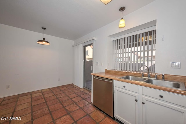 kitchen featuring pendant lighting, sink, white cabinetry, and stainless steel dishwasher