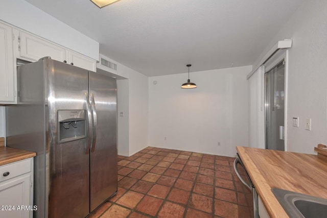 kitchen with decorative light fixtures, appliances with stainless steel finishes, sink, and white cabinetry