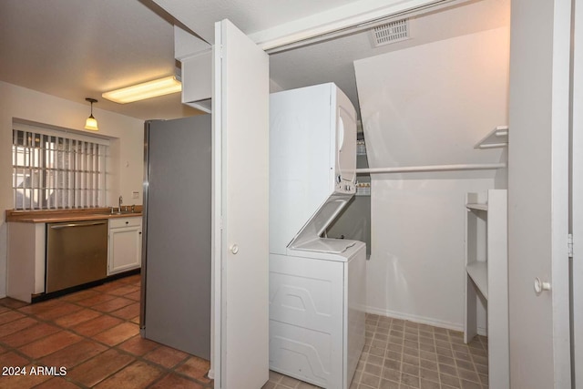 laundry room featuring stacked washer / dryer