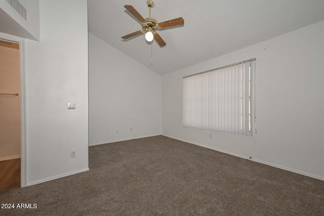 carpeted spare room featuring ceiling fan and vaulted ceiling