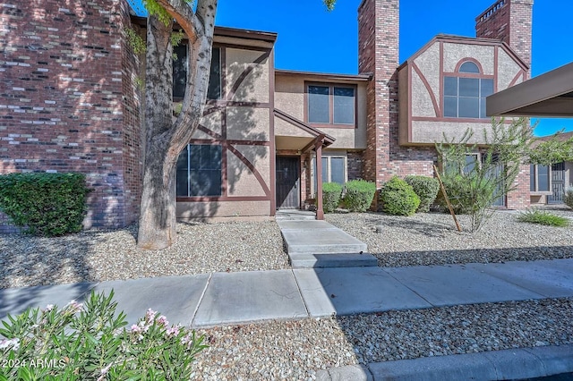 view of front of property with stucco siding and brick siding