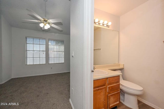 bathroom with vanity, toilet, and ceiling fan