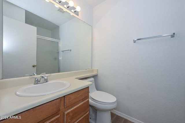 bathroom with vanity, a shower with shower door, toilet, and hardwood / wood-style flooring