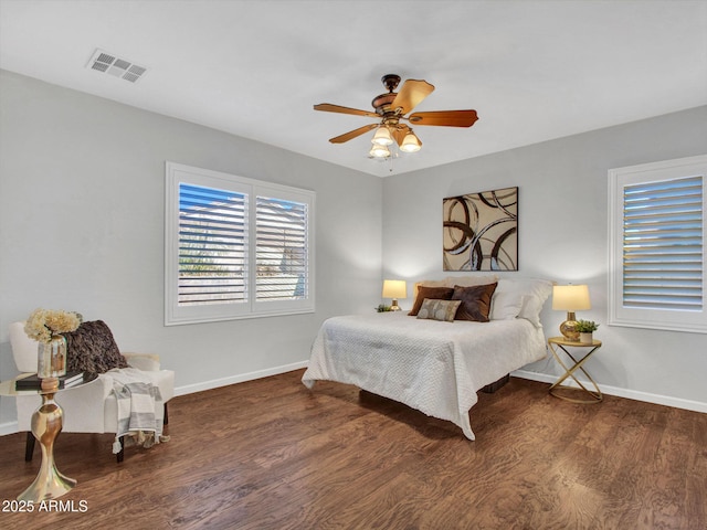 bedroom with ceiling fan and dark hardwood / wood-style floors