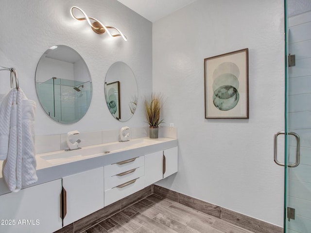 bathroom featuring vanity, hardwood / wood-style flooring, and walk in shower