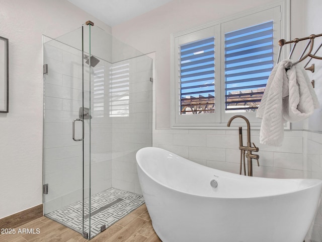 bathroom featuring tile walls and shower with separate bathtub