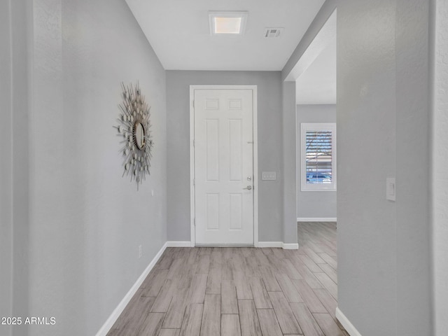 corridor with light wood-type flooring