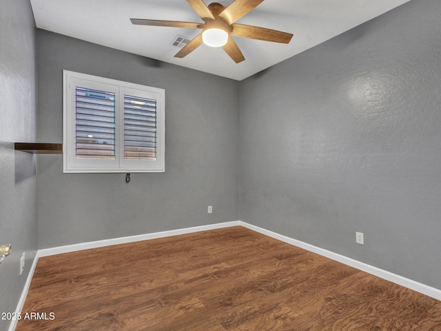 spare room featuring hardwood / wood-style floors and ceiling fan