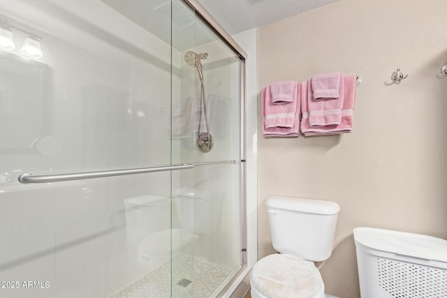 bathroom with toilet and an enclosed shower