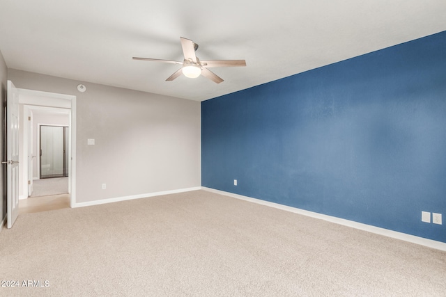 spare room with light carpet and ceiling fan