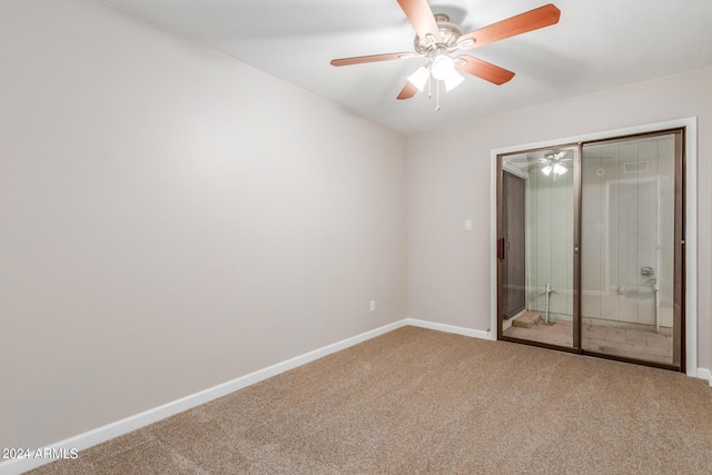 unfurnished room featuring ceiling fan and carpet floors