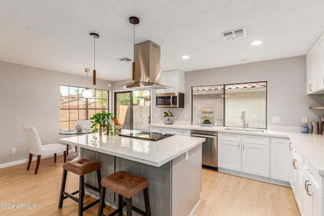2114 S El Marino, Mesa, AZ 85202 - kitchen with visible vents, a sink, a breakfast bar, stainless steel appliances, and island range hood