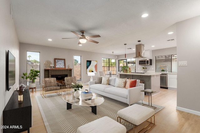 2114 S El Marino, Mesa, AZ 85202 - living area with a fireplace, light wood finished floors, visible vents, and ceiling fan