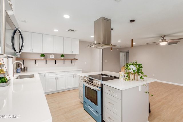 kitchen with white cabinets, a kitchen island, island range hood, light hardwood / wood-style flooring, and stainless steel appliances