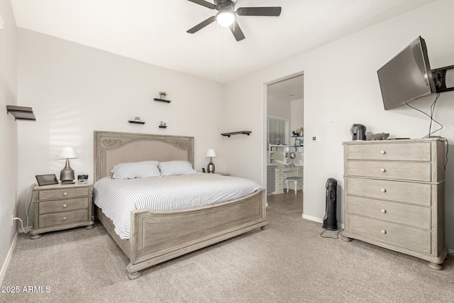 carpeted bedroom featuring ceiling fan and ensuite bathroom