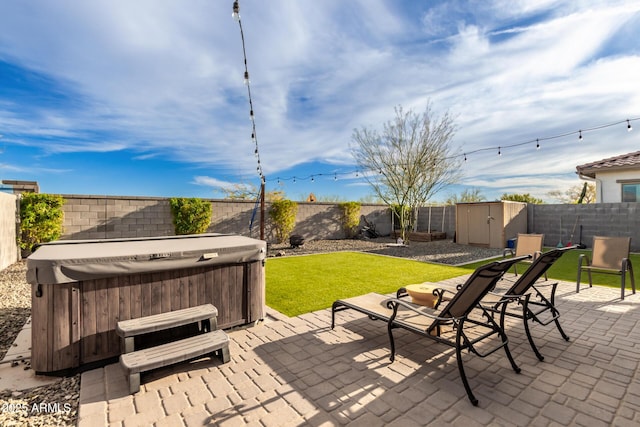 view of patio / terrace with a storage unit and a hot tub