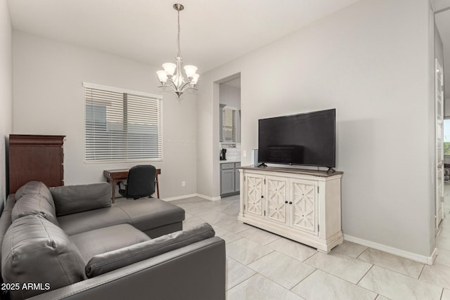 living room with a notable chandelier and light tile patterned flooring