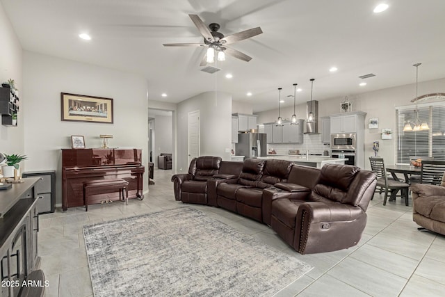 living room with ceiling fan with notable chandelier