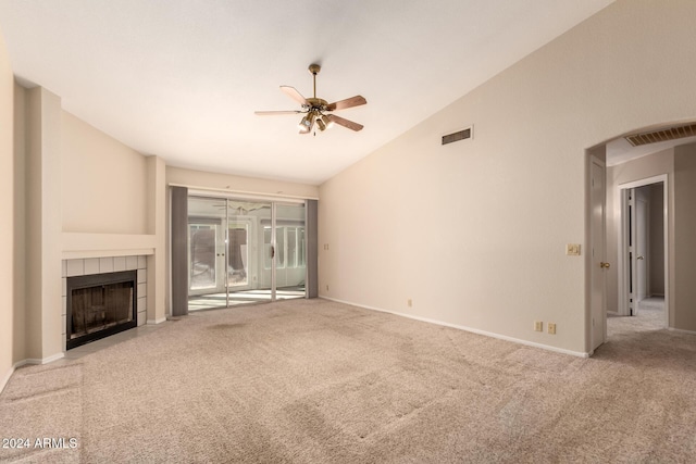 unfurnished living room featuring a fireplace, light carpet, vaulted ceiling, and ceiling fan