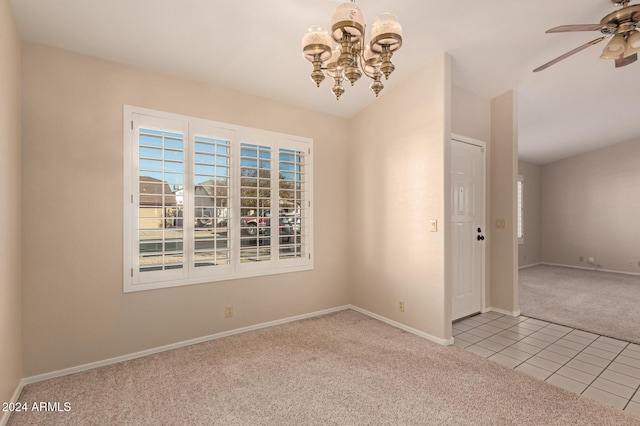 carpeted empty room with ceiling fan with notable chandelier