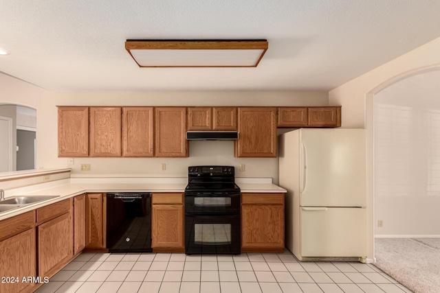 kitchen with light tile patterned flooring, sink, and black appliances