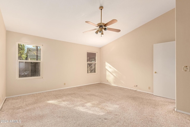 unfurnished room featuring ceiling fan, light colored carpet, and lofted ceiling