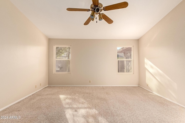 spare room with ceiling fan and light colored carpet