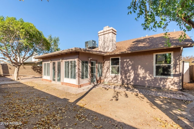 back of house with a sunroom and central AC unit